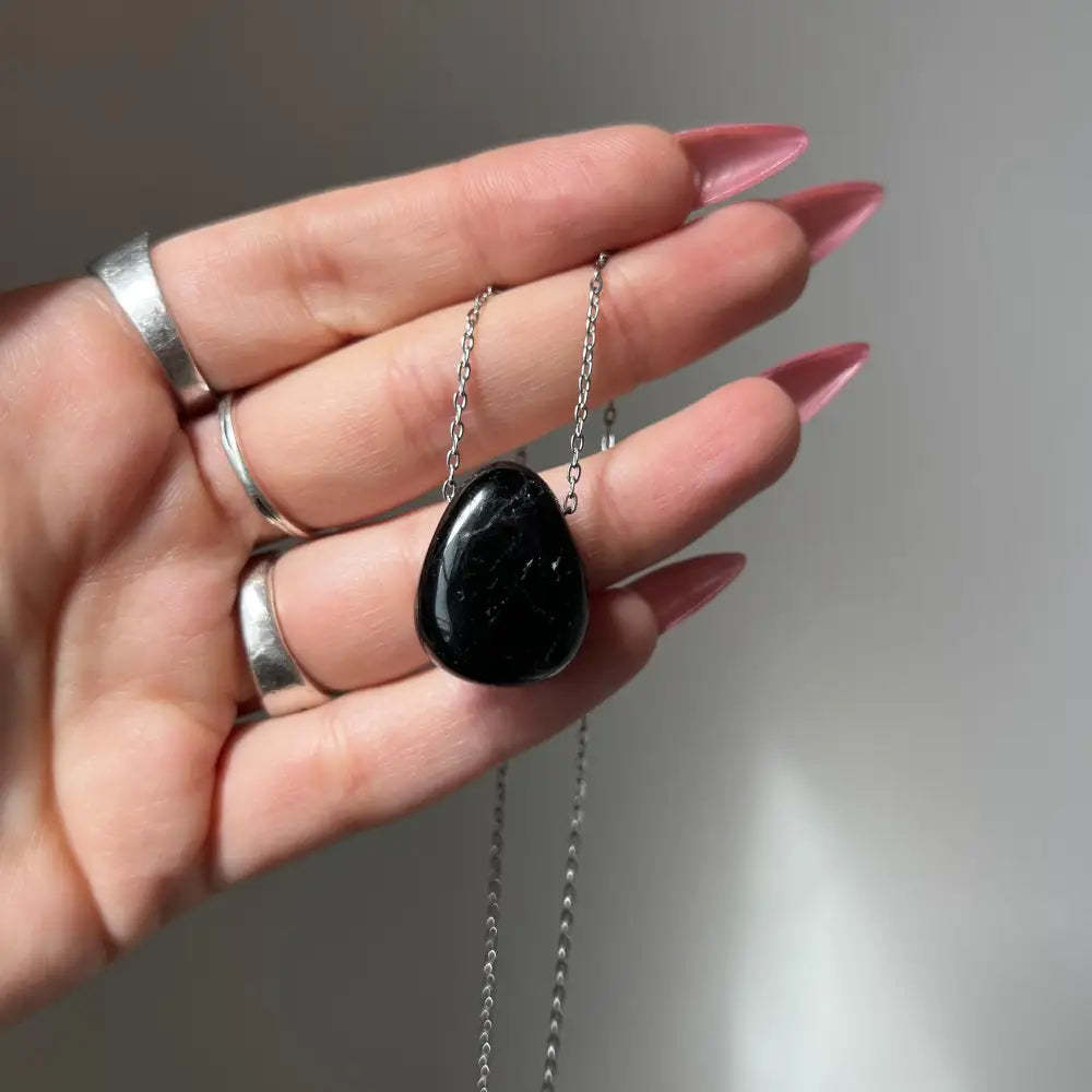 Black onyx pendant necklace with silver chain and ring detail for protection