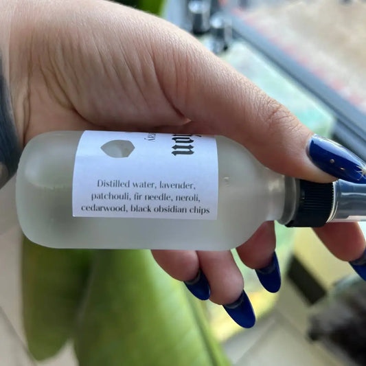 Frosted glass bottle of Protection Cleansing Spray with black cap