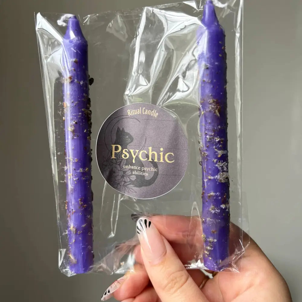 Purple psychic ritual candle with silver glitter in a clear pack