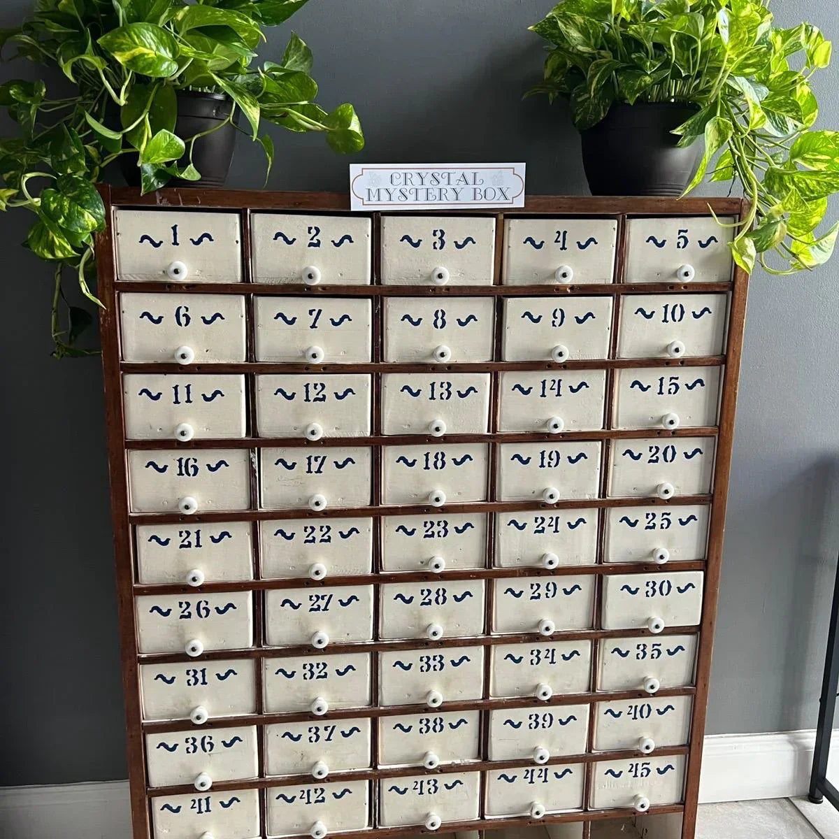 45-drawer apothecary cabinet with white drawers and dark wood frame