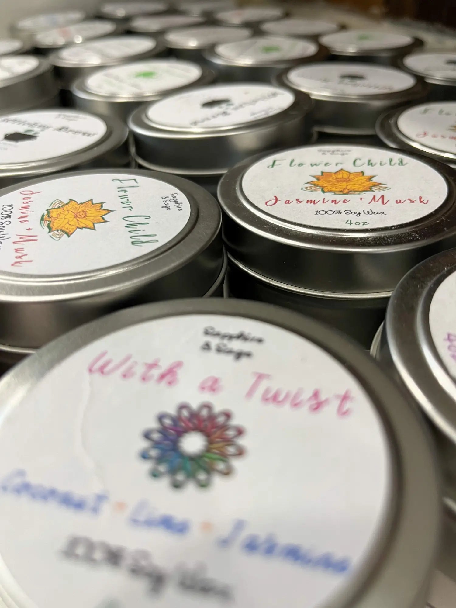 Silver tin candle with colorful flowers and With a Twist label