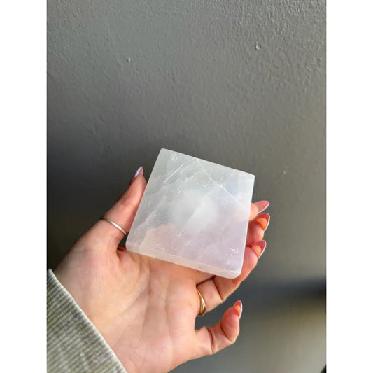 White square soap bar with natural edges in selenite sphere holder