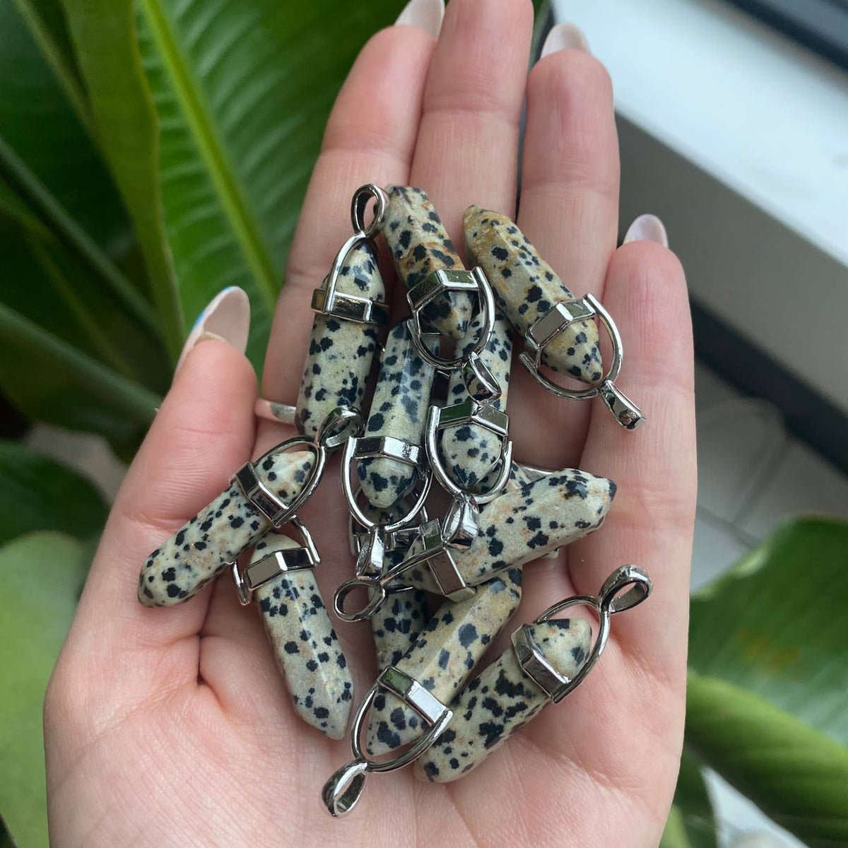 Dalmatian jasper pendant close up showing natural black tourmaline spot pattern