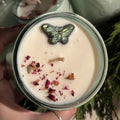 Candle with decorative elements, with more candles in the background