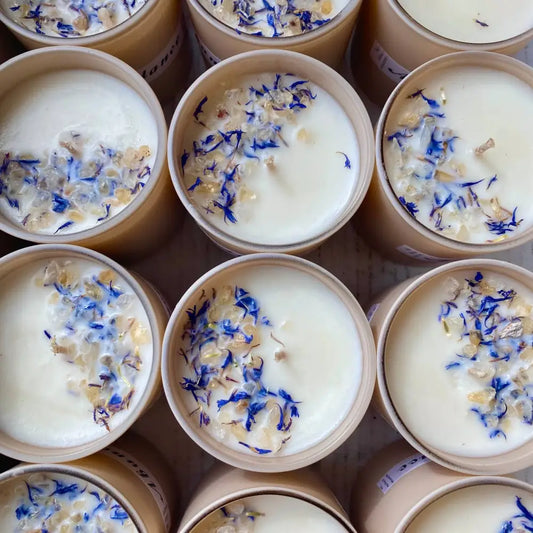 10 oz lavender soy candle in glass jar with blue petals