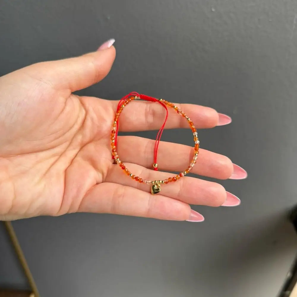 Orange beaded adjustable crystal gemstone bracelet with gold clasp and heart charm