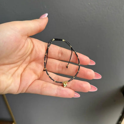 Black beaded adjustable crystal gemstone bracelet with gold heart charm