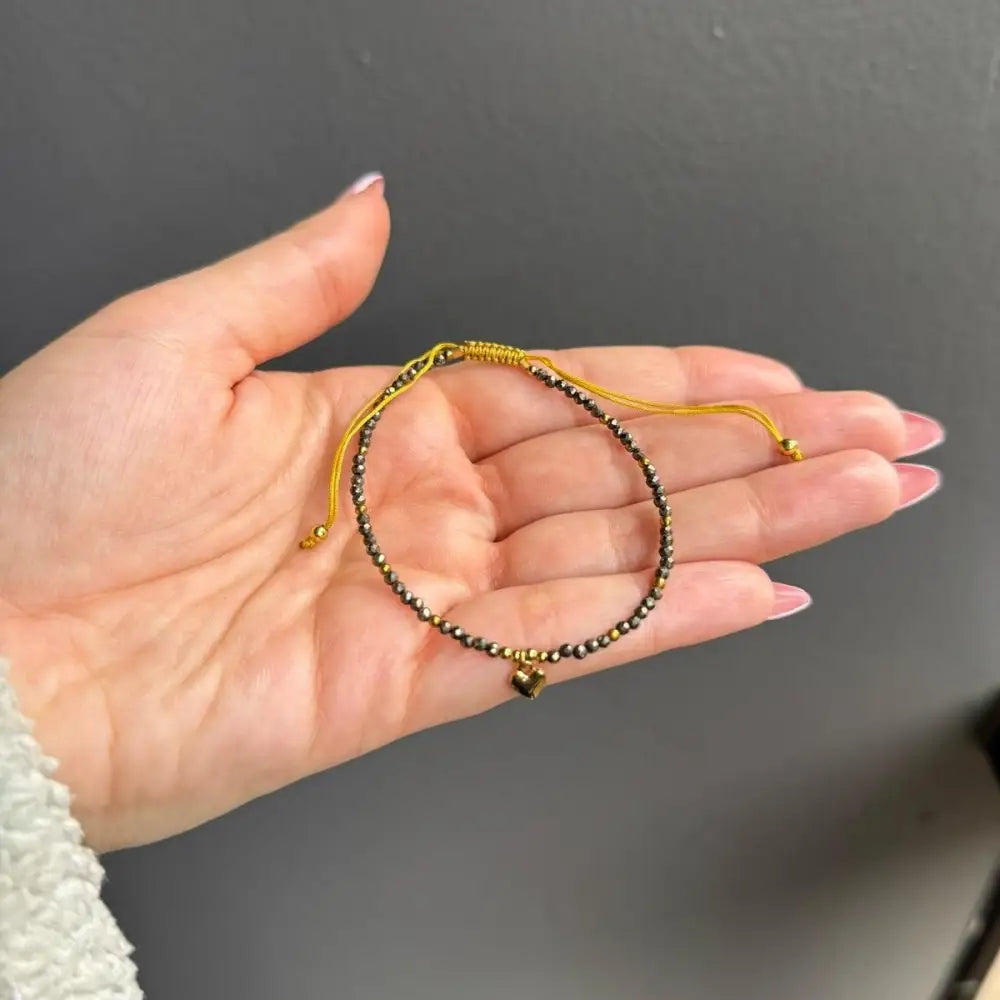 Gold and black beaded adjustable crystal gemstone bracelet with heart charm
