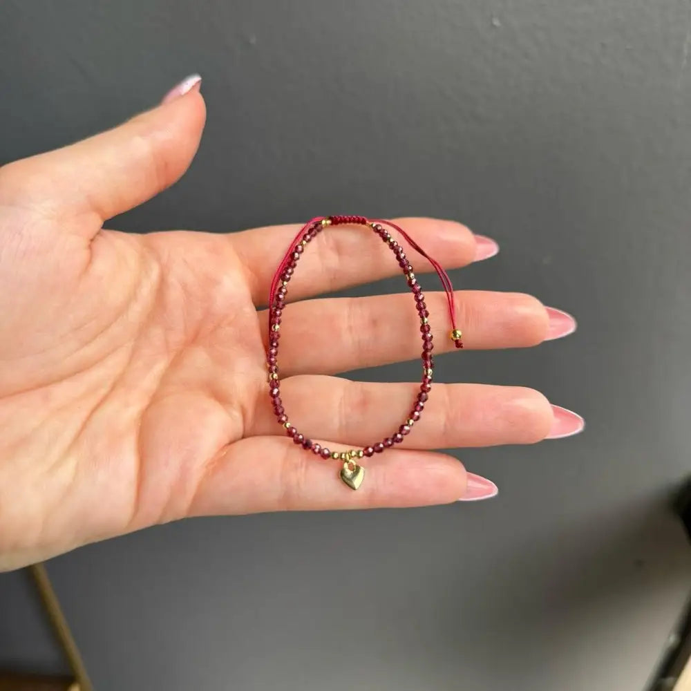 Red beaded crystal gemstone bracelet with gold heart charm, adjustable