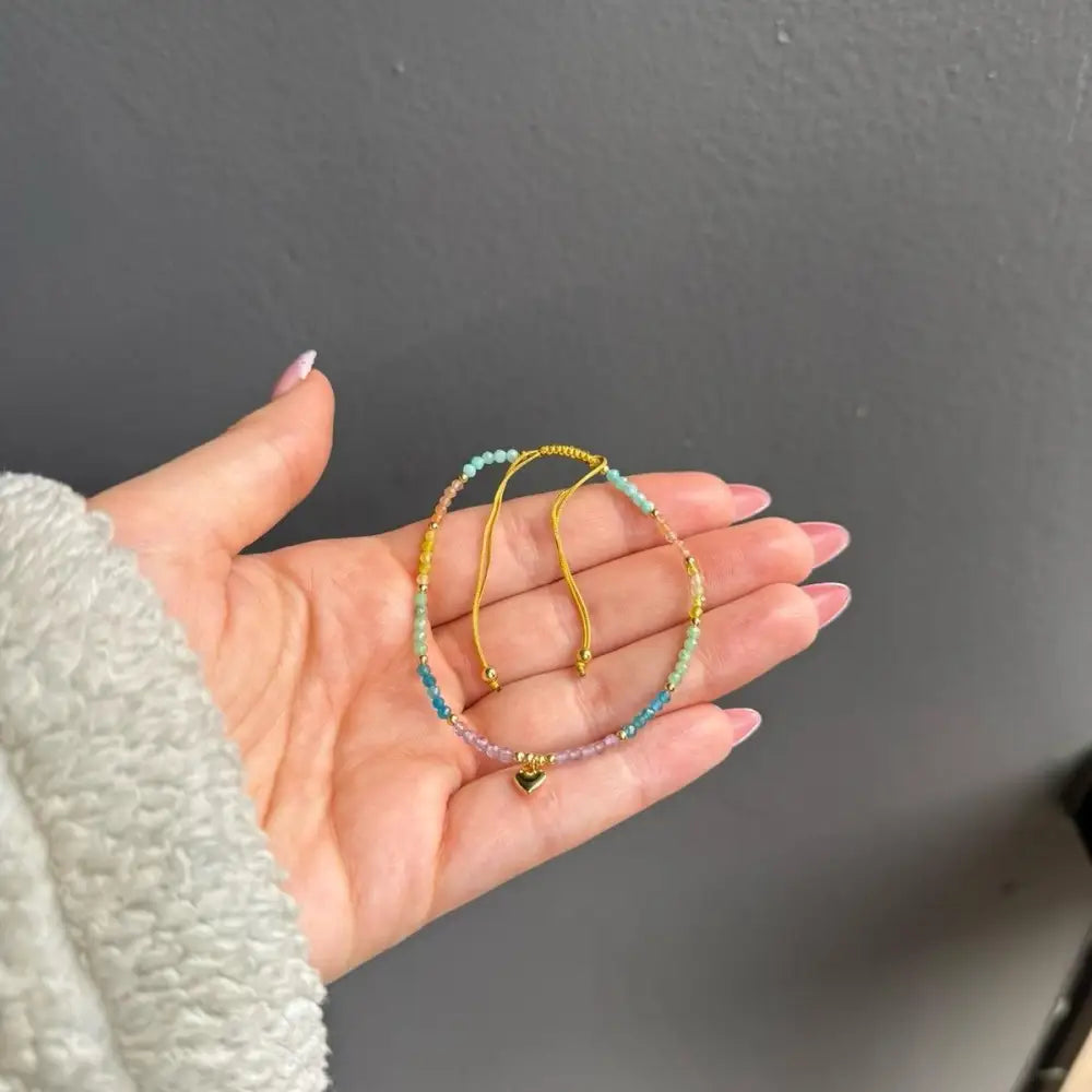 Gold hoop earrings with blue white beads and crystal heart charm