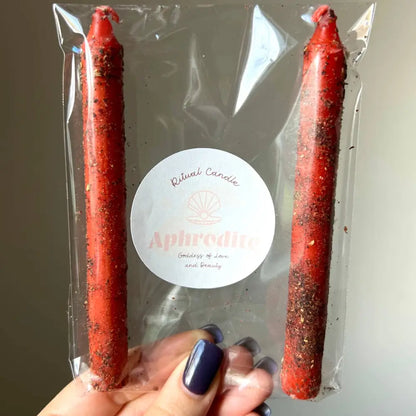 Red speckled Aphrodite Goddess Candle for love and beauty in clear plastic