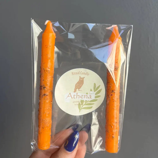 Orange taper candles in Athena Goddess Ritual Set packaging with owl logo