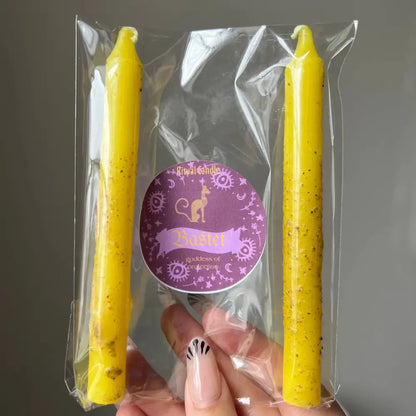 Yellow speckled beeswax Bastet protection ritual taper candles in clear pack with purple label