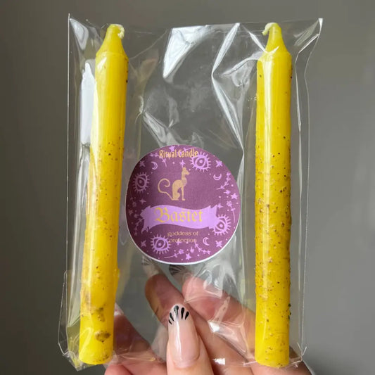Yellow speckled beeswax Bastet protection ritual taper candles in clear pack with purple label