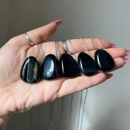 Black teardrop stone pendant necklace with silver chain for focus