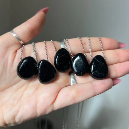 Black tourmaline teardrop pendants on silver chains for protection