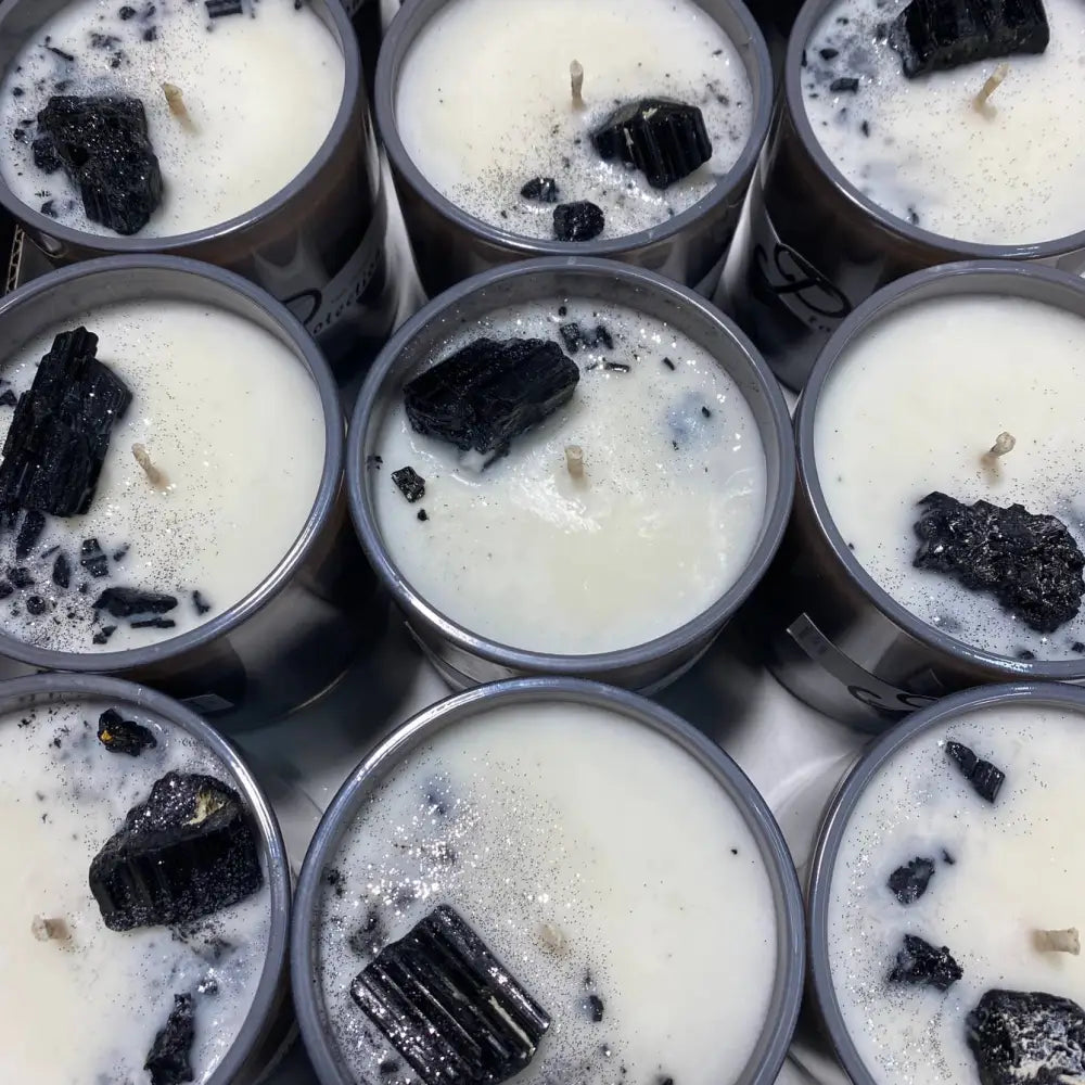 White soy candles in dark tins topped with black tourmaline crystals