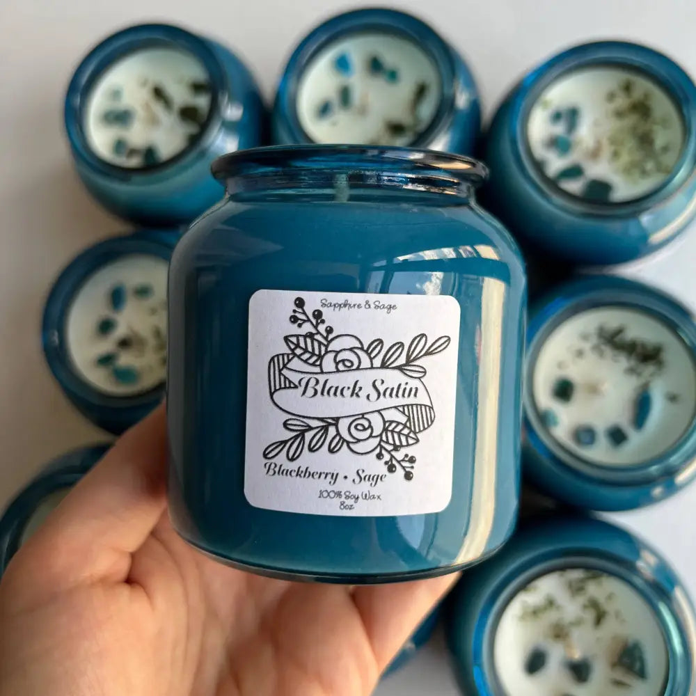Blue glass soy wax candle in reusable jar with blackberry sage scent