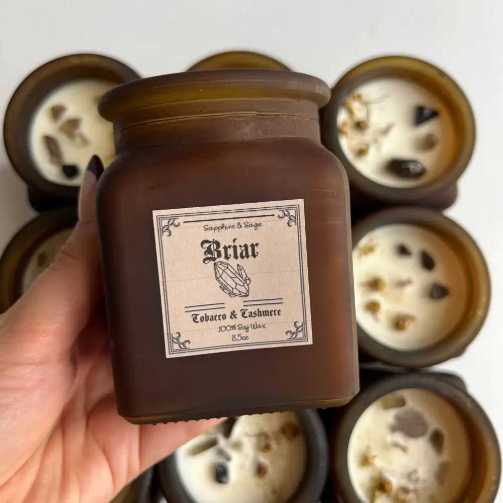 Briar tobacco and cashmere scented soy candle in matte amber glass jar