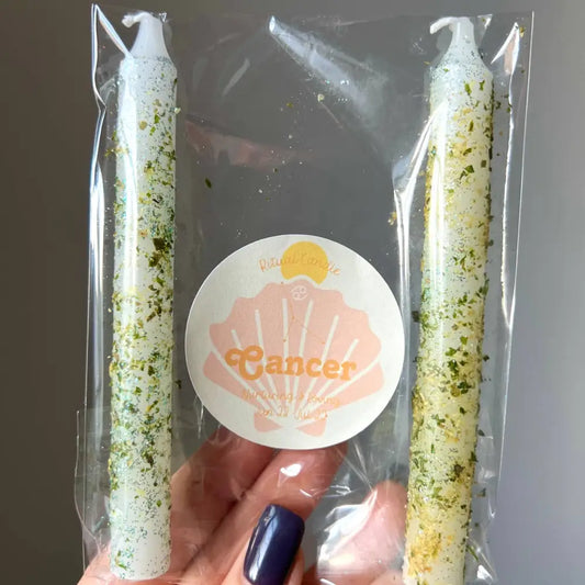 White and green speckled Cancer zodiac ritual candles in clear pack with herbs and oils