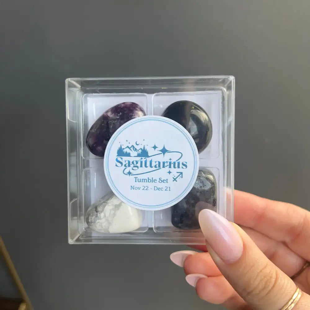 Sagittarius tumbled stone set with purple and white stones in clear box