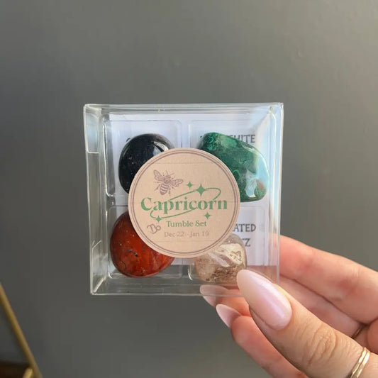 Capricorn tumbled stone set in clear acrylic box with colorful crystals