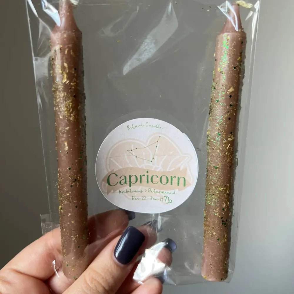 Capricorn ritual candles, two brown herb dressed tapers
