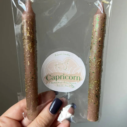 Gold glittery Capricorn zodiac ritual candles in clear plastic package