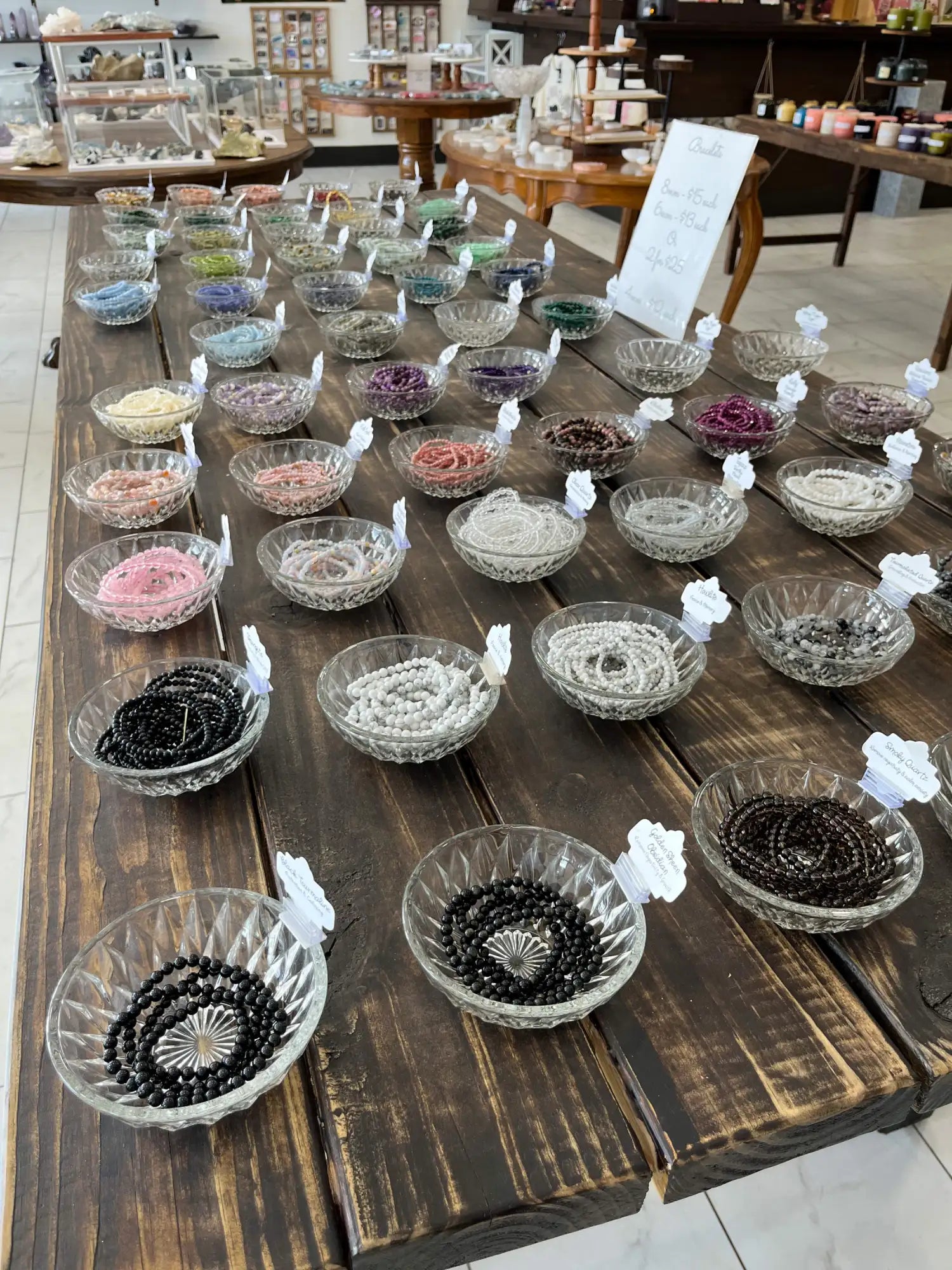 Clear glass bowls filled with colorful hair ties, black and white elastic bands.