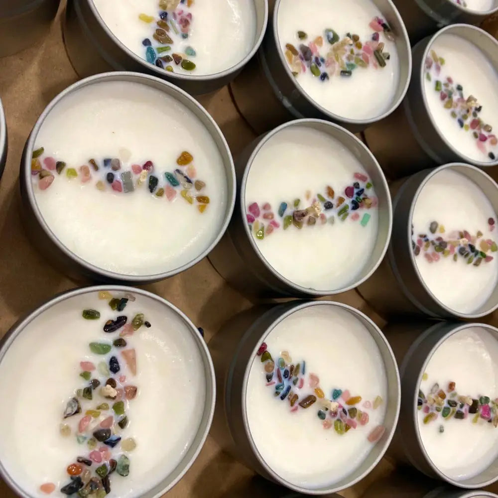 4oz tin candle with white wax and colorful gemstone inclusions for small spaces