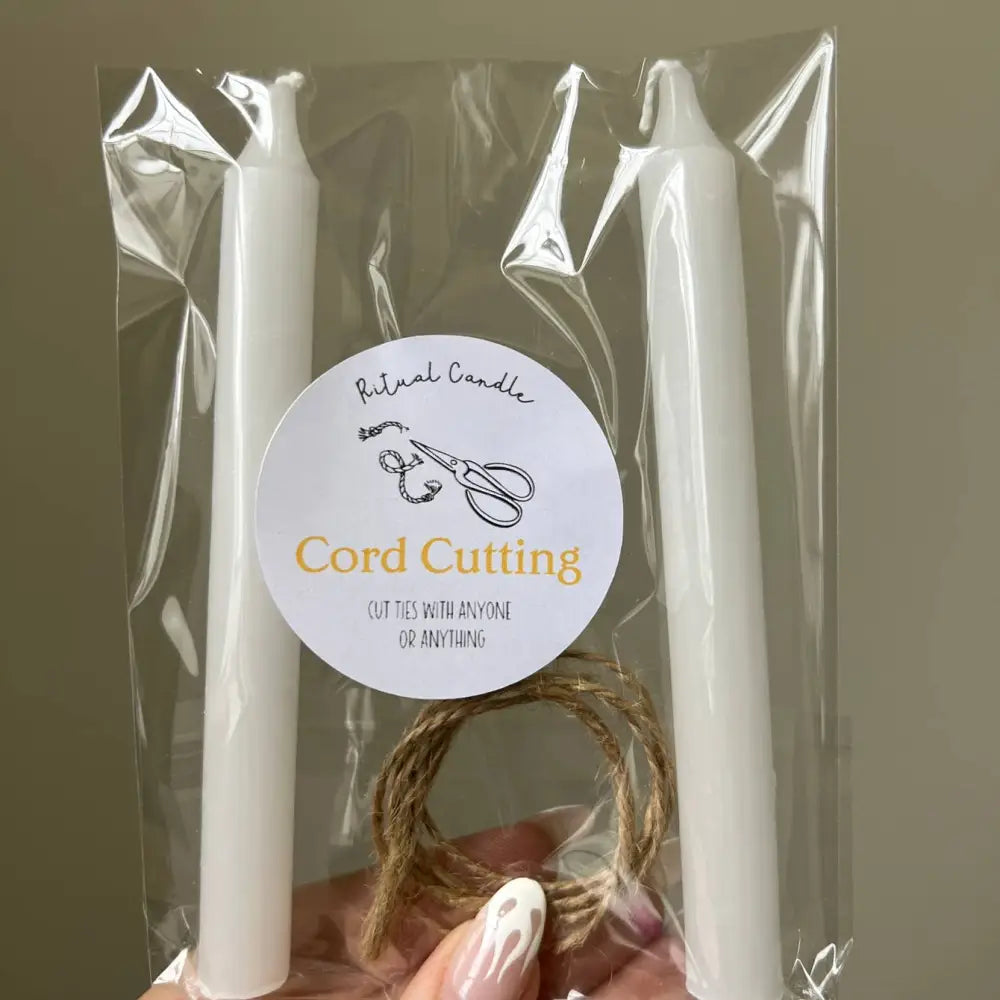 White taper candles with twine loop and scissors label for Cord Cutting Ritual