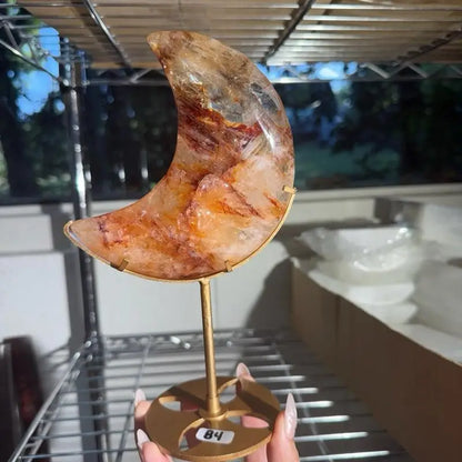 Moon-shaped fire quartz agate on gold geometric stand