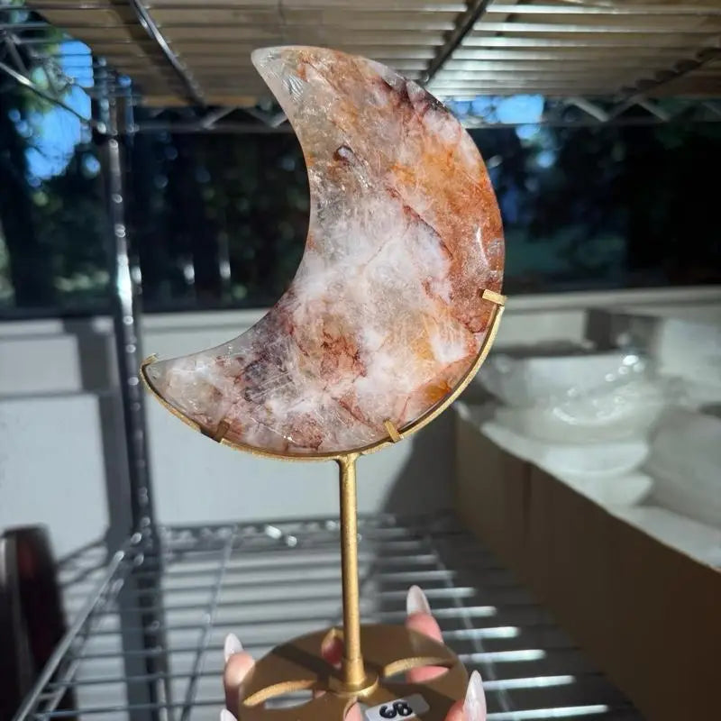 Moon-shaped agate slice on gold stand, Fire Quartz Crescent Moon figurine