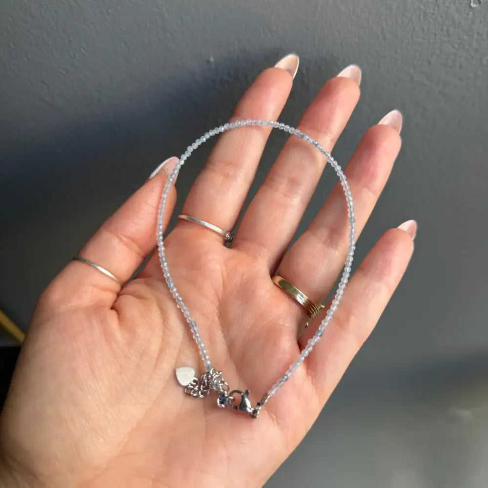 Silver beaded bracelet with heart charm, butterfly pendant, and 3mm crystals