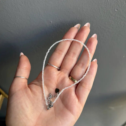 Silver beaded anklet with black stone charm for women