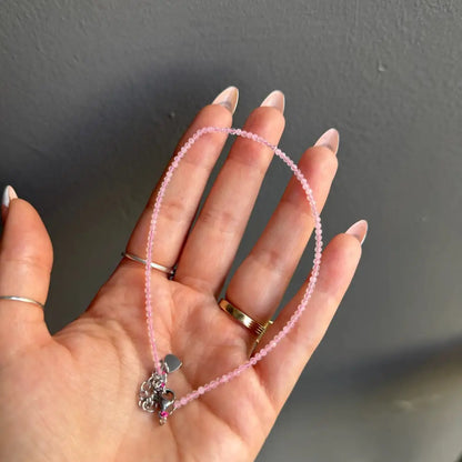 Pink beaded anklet with heart charm and gold clasp