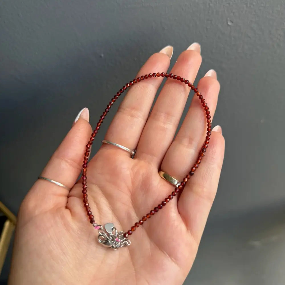 Red beaded anklet with silver butterfly charm and pink accents