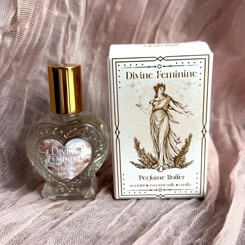 Divine feminine crystal-infused rollerball perfume with heart-shaped glass bottle and gold cap