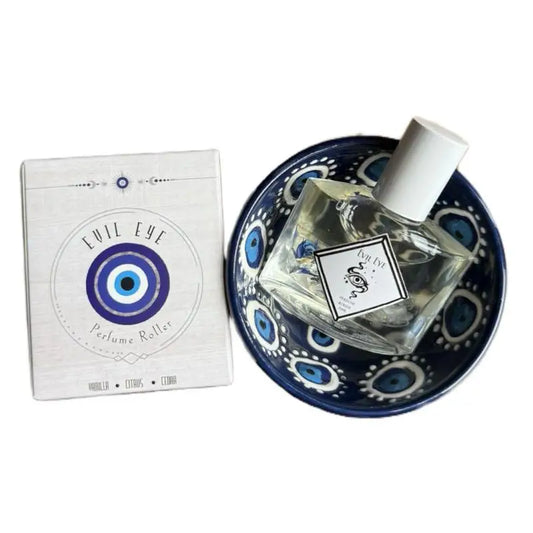 Silver rollerball perfume with blue evil eye on white box and bowl