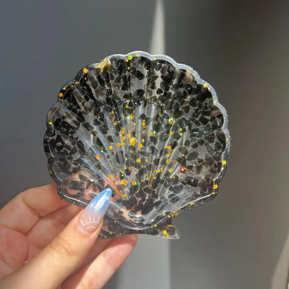 Clear scallop shell trinket dish with black gold glitter and crystals