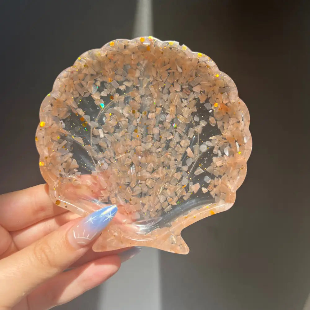 Rose quartz scalloped shell dish with embedded crystals and glossy finish