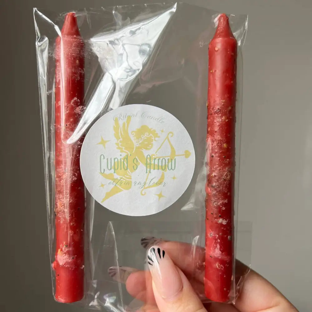 Red taper candles in clear pack with Cupids Arrow sticker