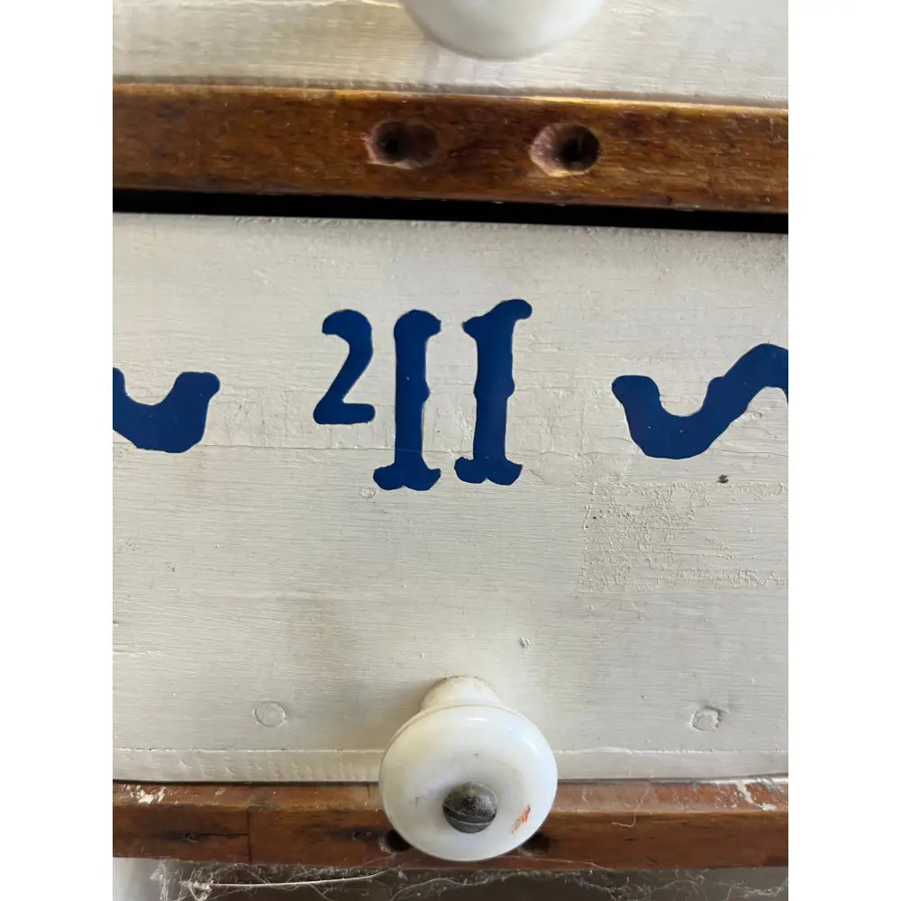 Blue wooden drawer handle with white plastic knob from Mystery Crystal Box