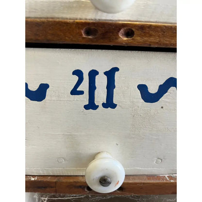 Blue wooden drawer handle with white plastic knob from Mystery Crystal Box