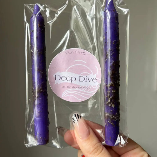 Purple spiral Deep Dive candle in clear packaging for Shadow Work rituals