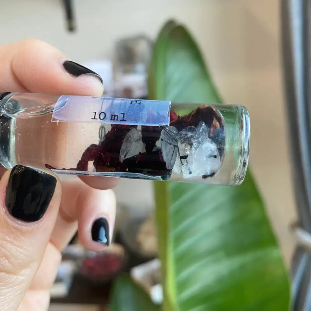 10ml glass vial of travel size perfume with red and white flowers