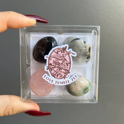 Clear acrylic box with polished garnet, moonstone, rose quartz, agate, and onyx gems