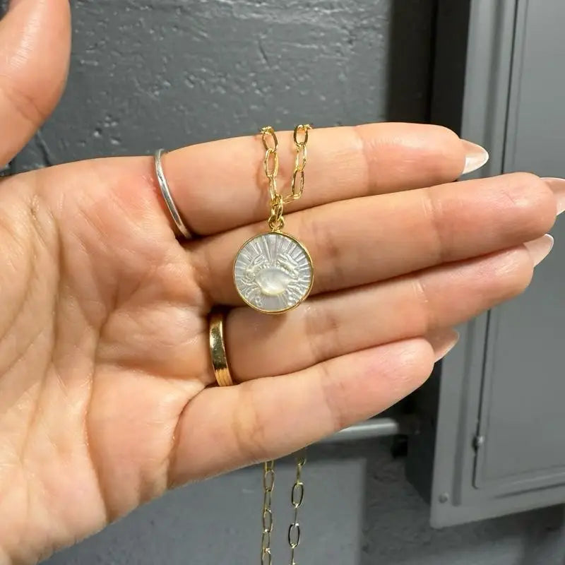 Gold coin zodiac pendant necklace, 15mm with intricate design and adjustable chain