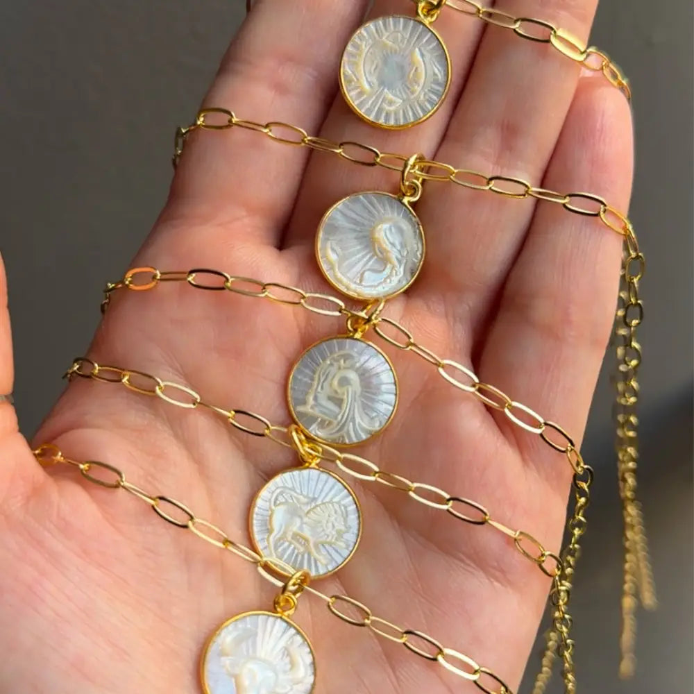 Gold coin charm bracelet with white stone inlays on 15mm Zodiac Pendant Necklace