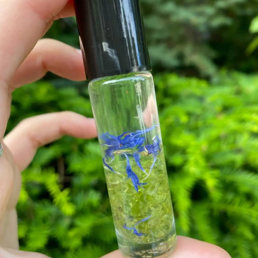 Green glass rollerball pen with blue flower accents and black cap for Coconut Oil Perfume Blend with Essential Oils